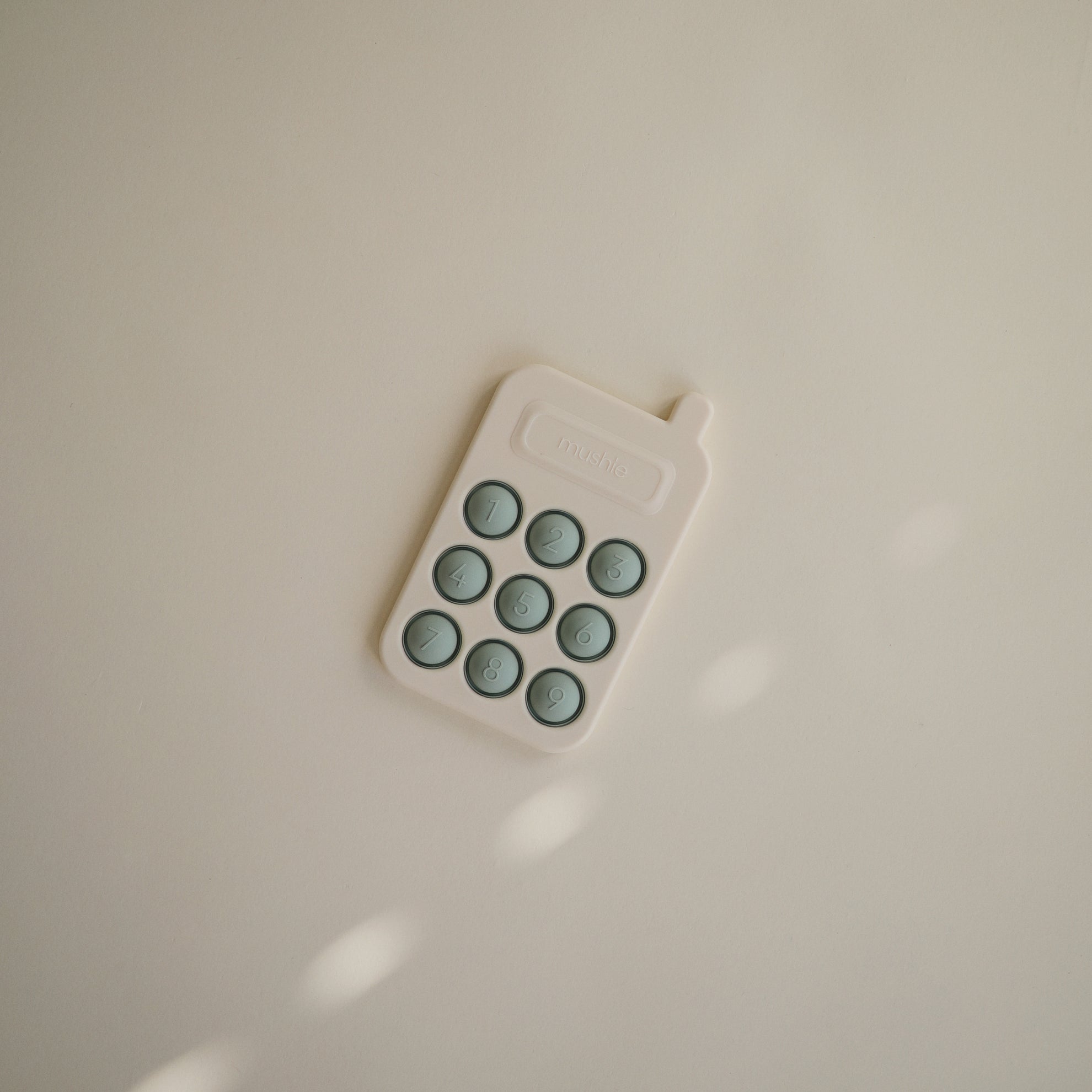 Mushie Phone Press Toy Cambridge Blue - Laadlee